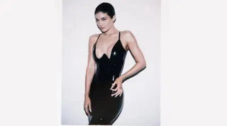 Sleek bodysuit-style dress in glossy black latex with a plunging neckline and thin straps.