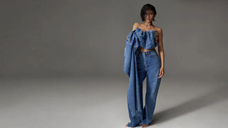 Capsule wardrobe essentials shown with a strapless denim crop top and wide-leg jeans in a studio look.
