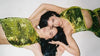 Sequin fashion ideas with two women posing in matching green sequin cut-out tops and skirts.