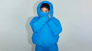 Trendy puffer jackets in vibrant blue with a hooded design perfect for cold-weather layering.