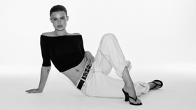 MODEL POSING IN BLACK TOP AND JEANS