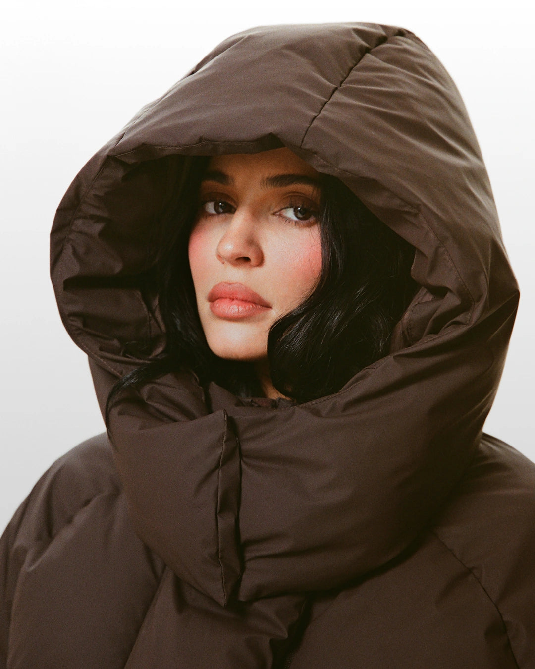 MODEL WEARING BROWN HOODED JACKET