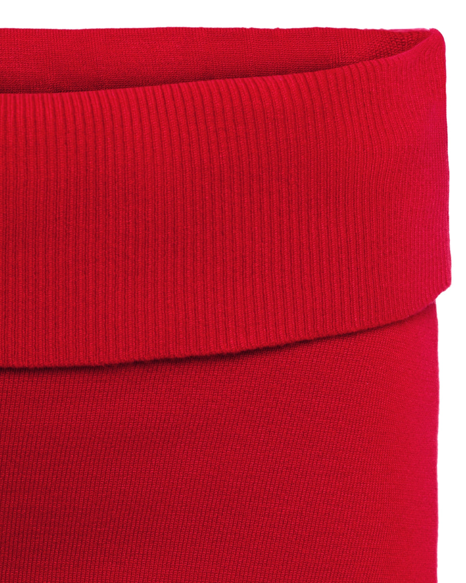 Red mini skort close-up showing ribbed elastic waistband and smooth knit fabric texture.