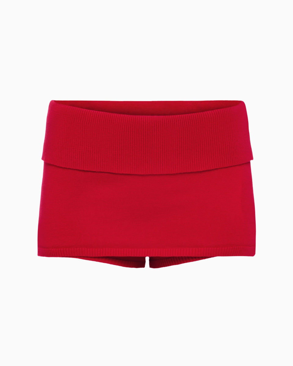 Mini skort in vibrant red featuring a wide ribbed waistband and form-fitting knit design on a white background.