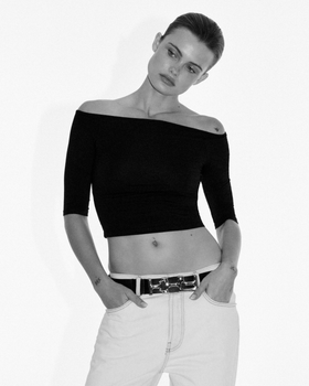 MODEL POSING IN BLACK TOP AND JEANS