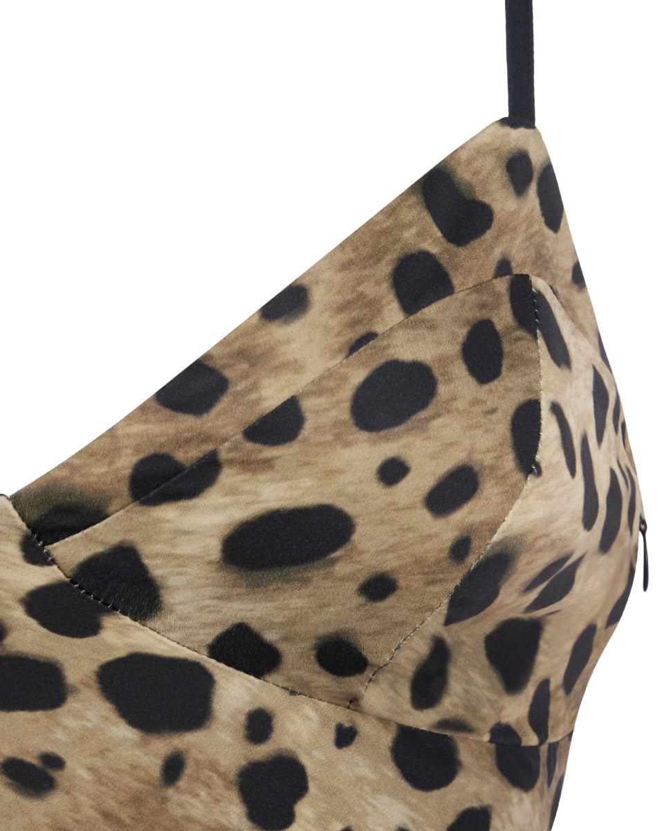 Leopard satin dress close-up showing the bust seam detail and black spaghetti strap on silky animal print fabric.