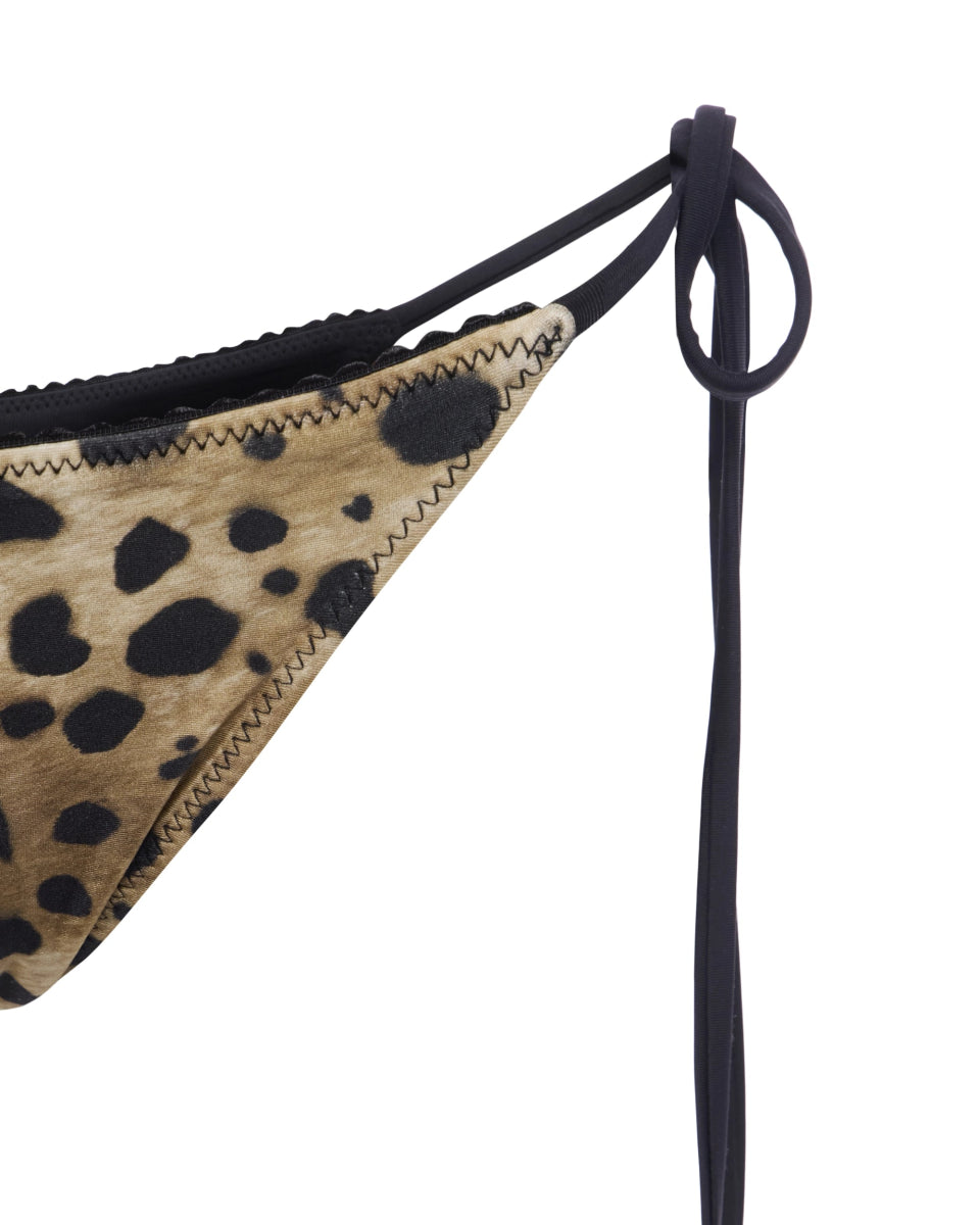 Satin leopard bikini bottom with black side ties and visible stitching on animal print fabric.
